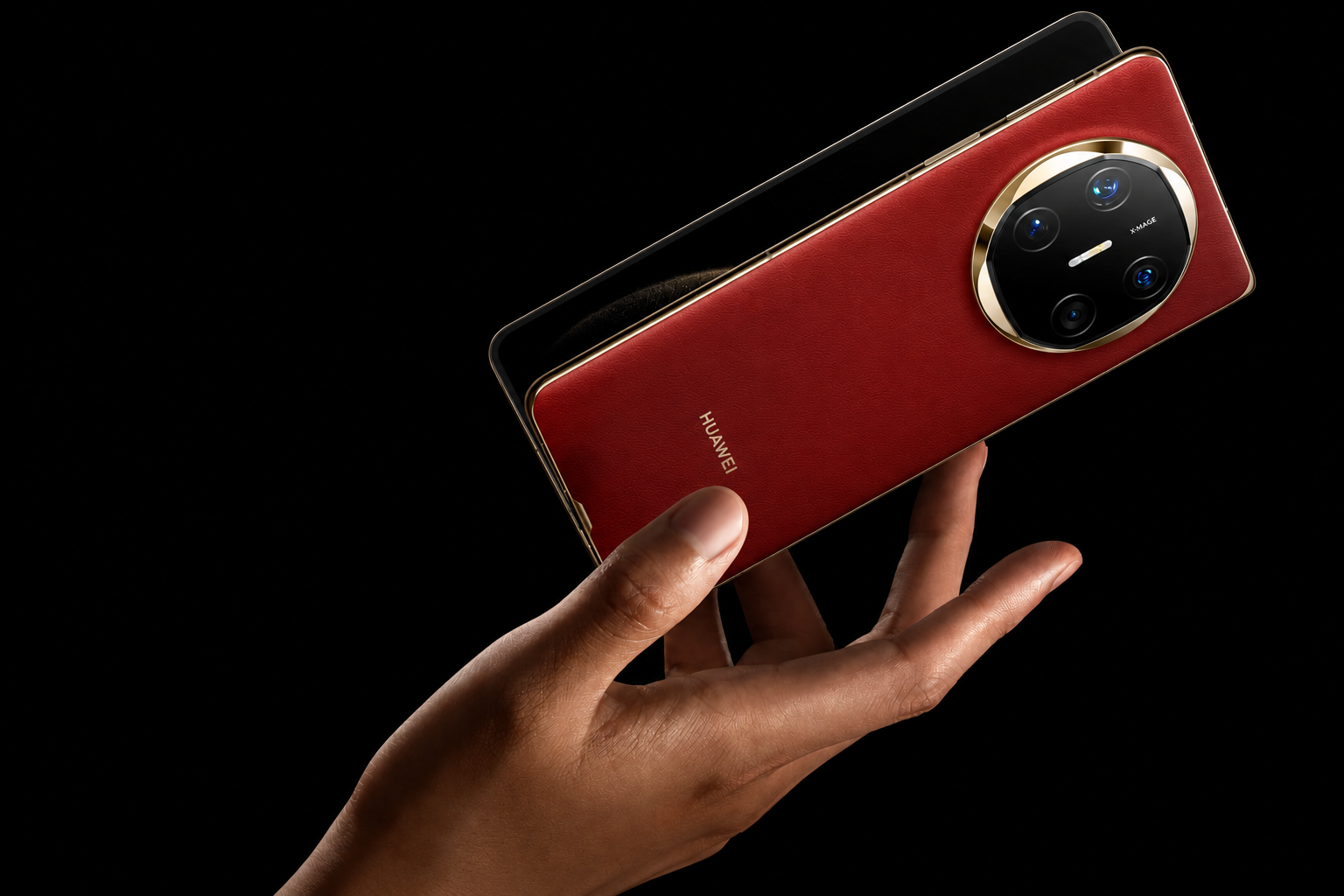 Premium red HUAWEI Mate X6 foldable smartphone held in hand with triple camera setup and luxury leather finish on a black background.